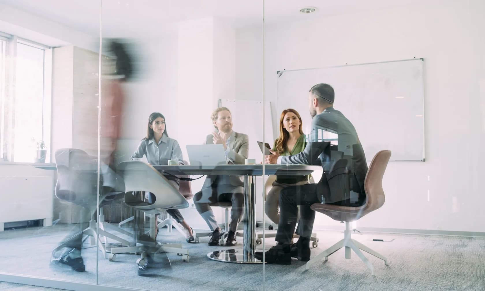 Blurred conference room table with people seated