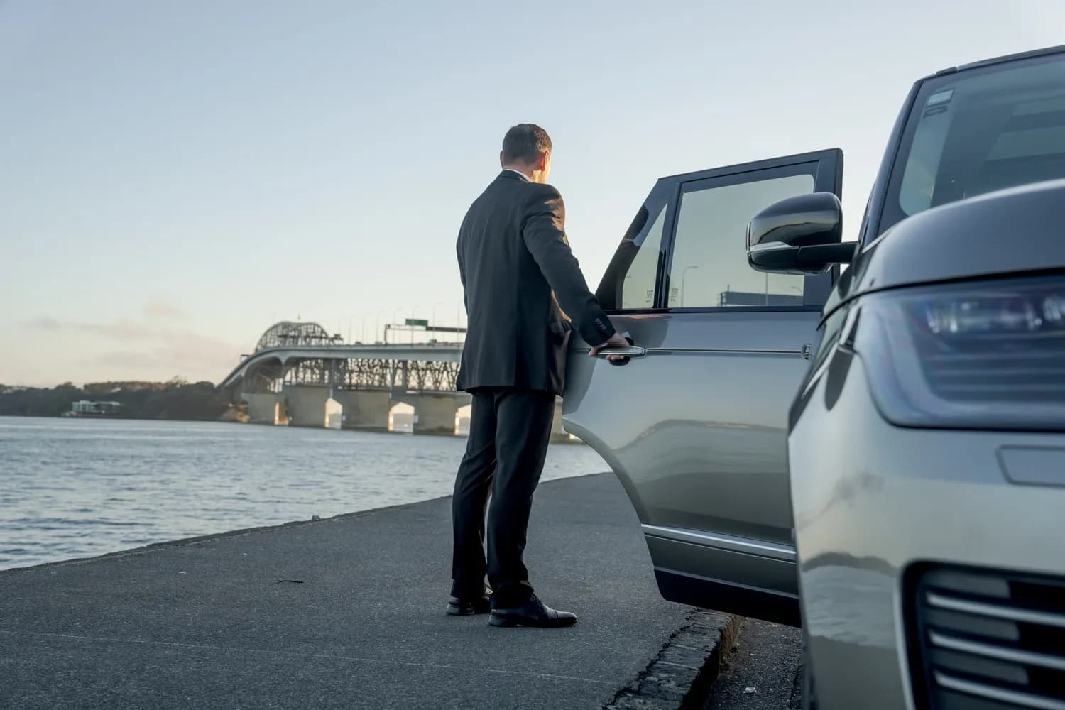 Man standing in Auckland beside car