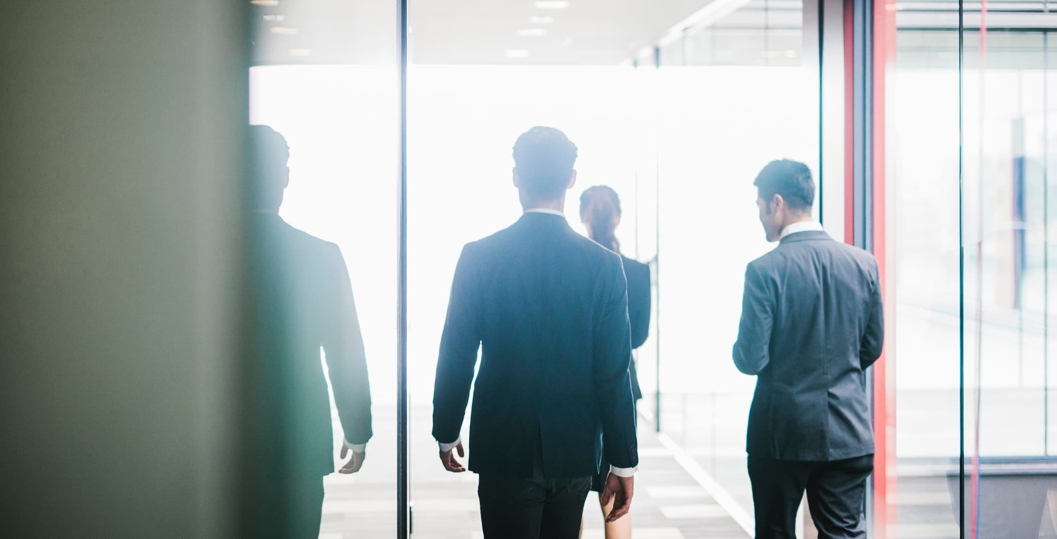 Men walking through modern office